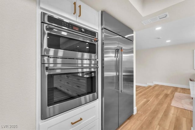 2868 Vista Del Sol Ave, Las Vegas, NV 89120 - kitchen featuring stainless steel appliances, light wood-style floors, white cabinetry, and recessed lighting