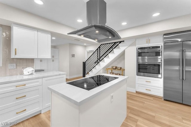 2868 Vista Del Sol Ave, Las Vegas, NV 89120 - kitchen with appliances with stainless steel finishes, island range hood, a center island, white cabinets, and recessed lighting
