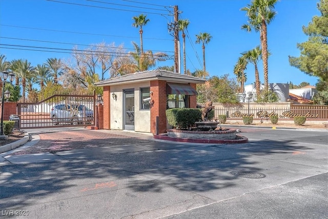 2868 Vista Del Sol Ave, Las Vegas, NV 89120 - view of asphalt road featuring a gate, curbs, and a gated entry
