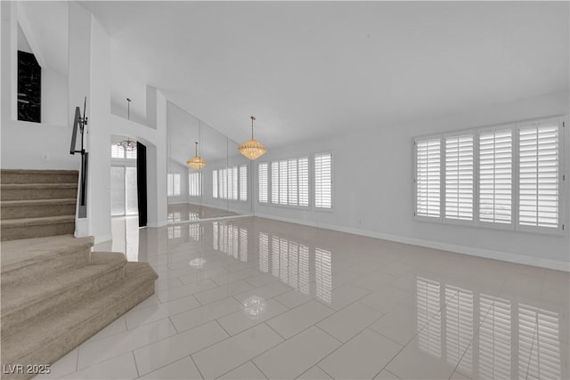 4604 Barnes Ct, Las Vegas, NV 89147 - spare room with healthy amount of natural light, tile patterned flooring, stairway, and high vaulted ceiling