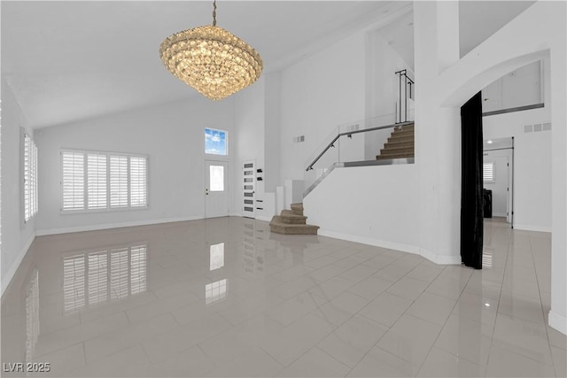 4604 Barnes Ct, Las Vegas, NV 89147 - unfurnished living room featuring high vaulted ceiling, a chandelier, stairs, and arched walkways