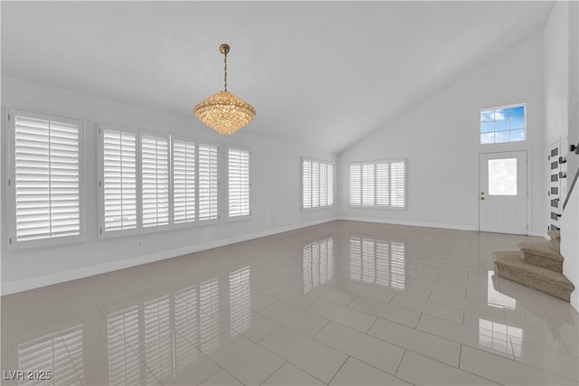 4604 Barnes Ct, Las Vegas, NV 89147 - tiled empty room featuring stairway and high vaulted ceiling