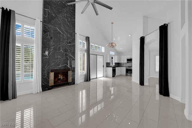 4604 Barnes Ct, Las Vegas, NV 89147 - unfurnished living room with high vaulted ceiling, a premium fireplace, a ceiling fan, recessed lighting, and light tile patterned floors