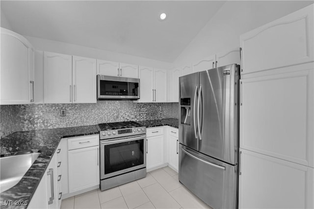 4604 Barnes Ct, Las Vegas, NV 89147 - kitchen featuring appliances with stainless steel finishes, lofted ceiling, white cabinets, light tile patterned floors, and backsplash