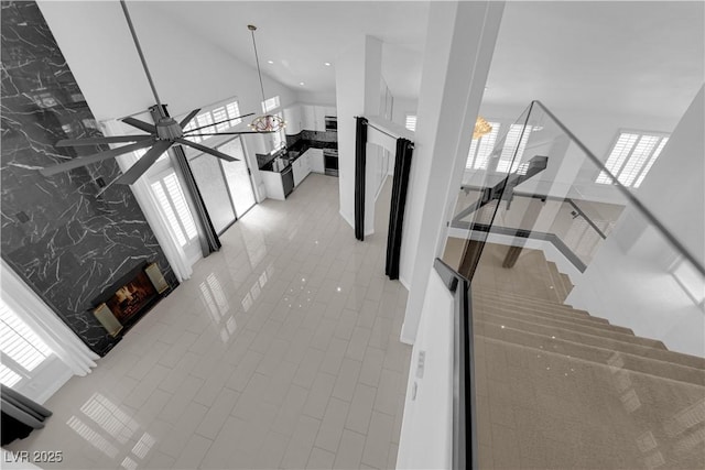 4604 Barnes Ct, Las Vegas, NV 89147 - hallway with tile patterned flooring and an upstairs landing