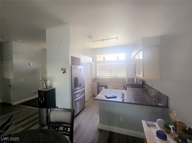4764 Wild Draw Dr, North Las Vegas, NV 89031 - kitchen featuring stainless steel appliances, wood finished floors, and a peninsula