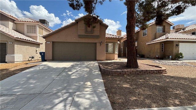 1081 Overture Dr, Las Vegas, NV 89123 - view of front of house featuring concrete driveway, stucco siding, a tile roof, and a garage