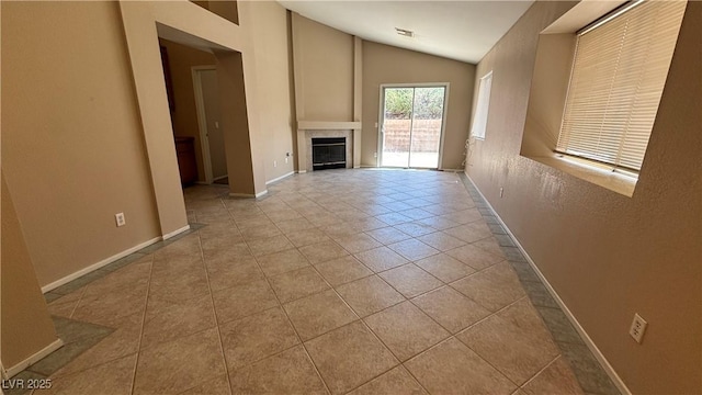 1081 Overture Dr, Las Vegas, NV 89123 - unfurnished living room featuring vaulted ceiling, a fireplace, and tile patterned floors