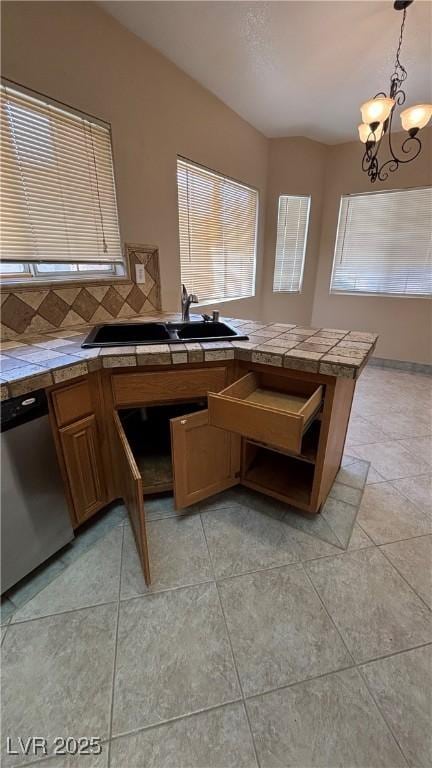 1081 Overture Dr, Las Vegas, NV 89123 - kitchen featuring a chandelier, tasteful backsplash, dishwasher, pendant lighting, and brown cabinetry