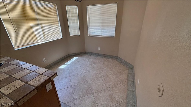 1081 Overture Dr, Las Vegas, NV 89123 - tiled spare room featuring baseboards