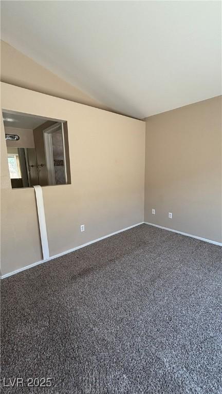 1081 Overture Dr, Las Vegas, NV 89123 - spare room featuring baseboards and vaulted ceiling