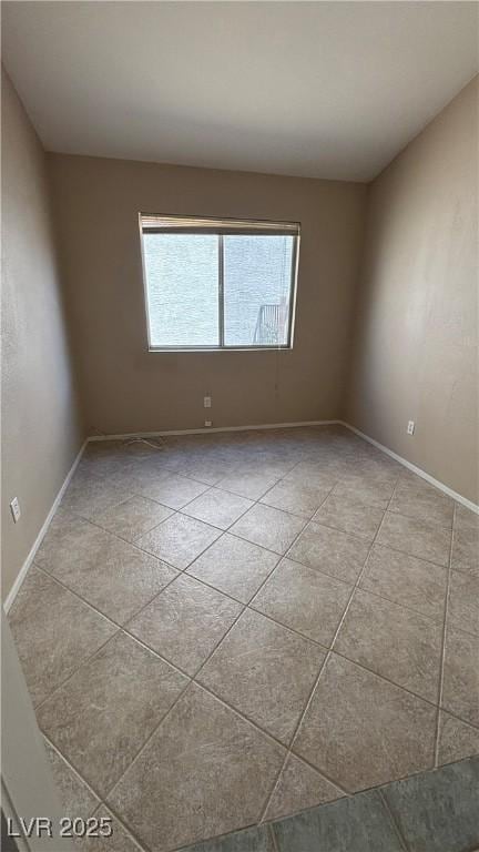 1081 Overture Dr, Las Vegas, NV 89123 - unfurnished room featuring baseboards and light tile patterned floors