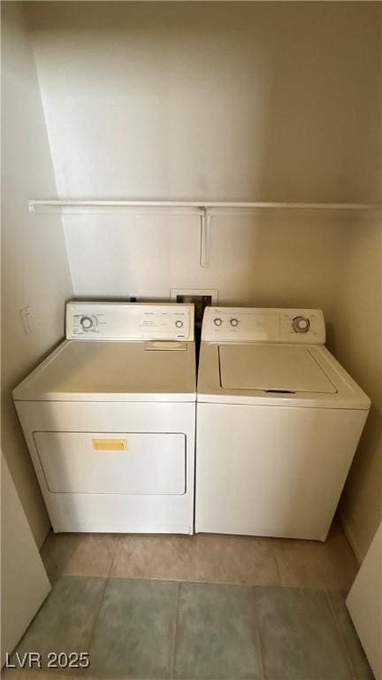 1081 Overture Dr, Las Vegas, NV 89123 - laundry room with washing machine and clothes dryer and light tile patterned floors