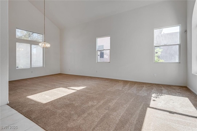 8771 Martinique Bay Ln, Las Vegas, NV 89147 - empty room featuring light colored carpet, a chandelier, and high vaulted ceiling