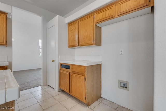 8771 Martinique Bay Ln, Las Vegas, NV 89147 - kitchen featuring tile countertops, light carpet, and light tile patterned floors