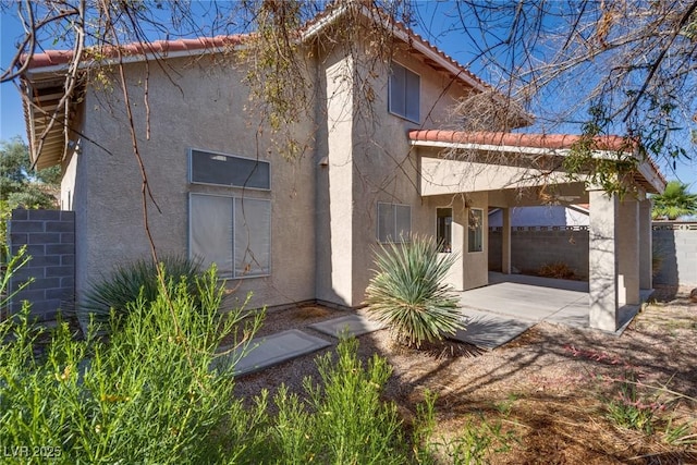 8771 Martinique Bay Ln, Las Vegas, NV 89147 - view of front of home with stucco siding, a patio, and a tile roof