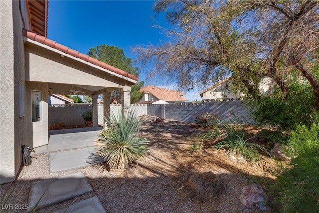 8771 Martinique Bay Ln, Las Vegas, NV 89147 - fenced backyard featuring a patio area and a ceiling fan