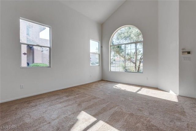 8771 Martinique Bay Ln, Las Vegas, NV 89147 - carpeted empty room featuring high vaulted ceiling and baseboards