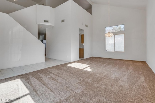 8771 Martinique Bay Ln, Las Vegas, NV 89147 - tiled spare room with carpet flooring, a chandelier, and high vaulted ceiling