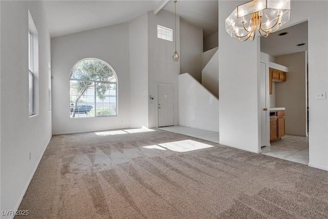 8771 Martinique Bay Ln, Las Vegas, NV 89147 - entryway featuring light colored carpet, high vaulted ceiling, a chandelier, and beam ceiling