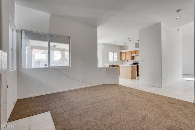 8771 Martinique Bay Ln, Las Vegas, NV 89147 - unfurnished living room featuring light carpet, light tile patterned floors, and ceiling fan