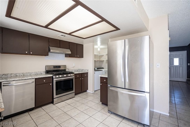 5241 Janfred Ct Unit 18, Las Vegas, NV 89103 - kitchen with appliances with stainless steel finishes, separate washer and dryer, light tile patterned floors, and dark brown cabinets