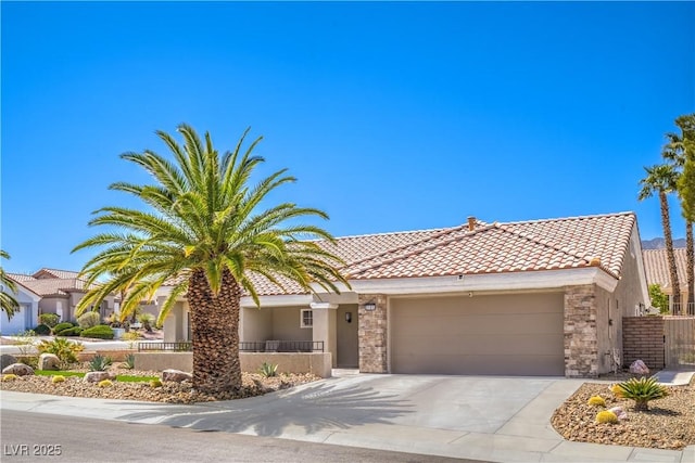 3101 Hayden Ct, Las Vegas, NV 89134 - view of front facade with a tile roof, a garage, stucco siding, concrete driveway, and stone siding
