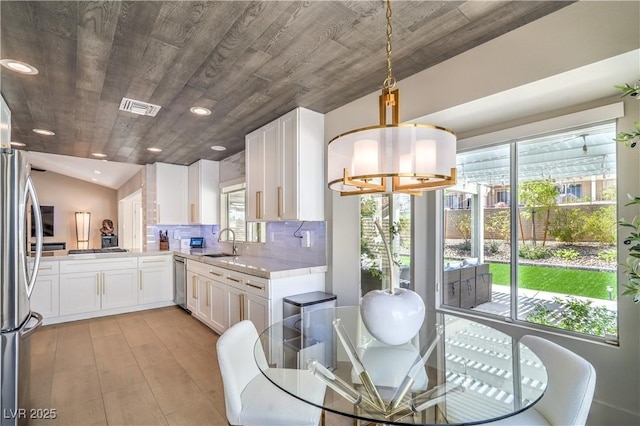 3101 Hayden Ct, Las Vegas, NV 89134 - dining space with plenty of natural light, light wood-type flooring, recessed lighting, vaulted ceiling, and a chandelier