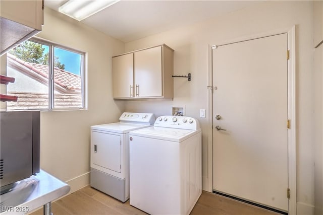 3101 Hayden Ct, Las Vegas, NV 89134 - laundry room featuring cabinet space, washing machine and clothes dryer, and light wood-style flooring