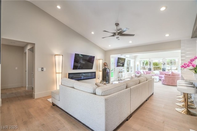3101 Hayden Ct, Las Vegas, NV 89134 - living area featuring ceiling fan, recessed lighting, light wood-type flooring, a glass covered fireplace, and high vaulted ceiling