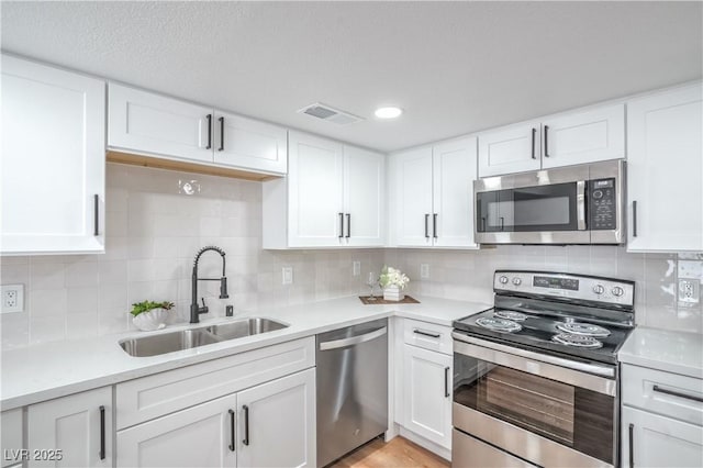 3459 One Nation Ave, Las Vegas, NV 89121 - kitchen with appliances with stainless steel finishes, light countertops, and white cabinetry