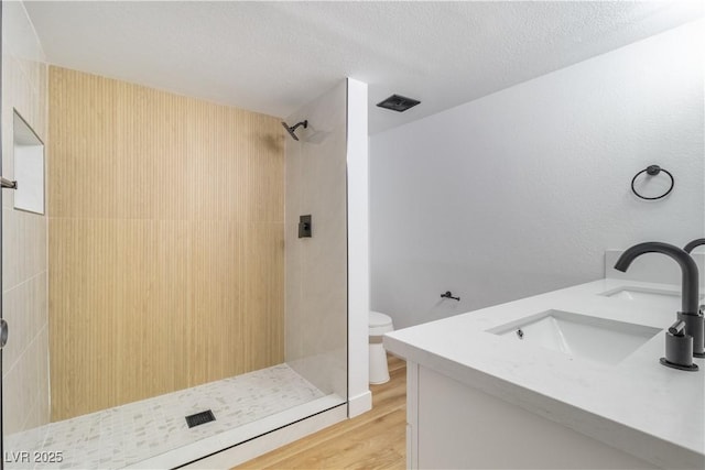 3459 One Nation Ave, Las Vegas, NV 89121 - bathroom with a tile shower, vanity, and wood finished floors