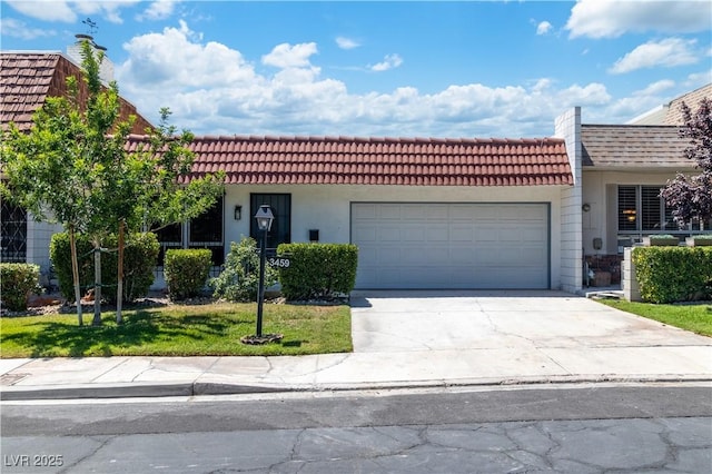 3459 One Nation Ave, Las Vegas, NV 89121 - view of front facade featuring an attached garage, driveway, a front lawn, stucco siding, and a tile roof