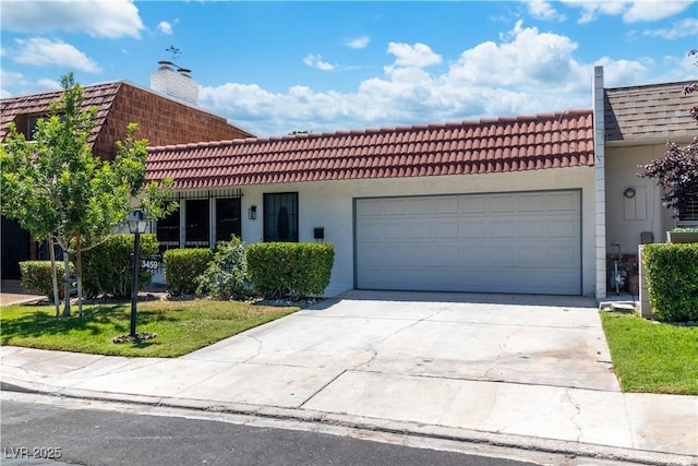 3459 One Nation Ave, Las Vegas, NV 89121 - view of front of home featuring a garage, driveway, stucco siding, a chimney, and a tile roof