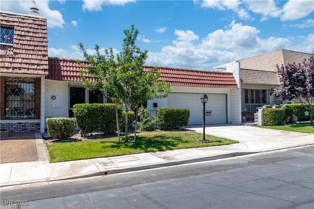 3459 One Nation Ave, Las Vegas, NV 89121 - view of front of house featuring driveway, a garage, a front lawn, and stucco siding