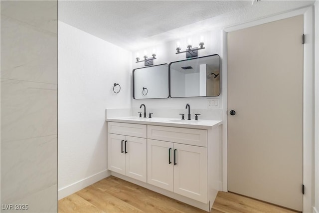 3459 One Nation Ave, Las Vegas, NV 89121 - full bathroom featuring double vanity, wood finished floors, and a textured ceiling