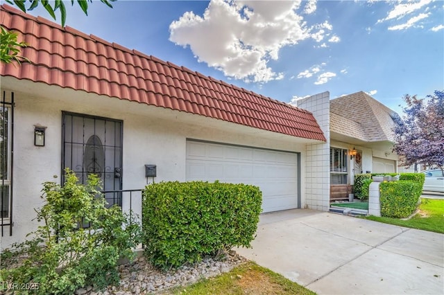 3459 One Nation Ave, Las Vegas, NV 89121 - view of side of property with a tile roof, an attached garage, stucco siding, and driveway