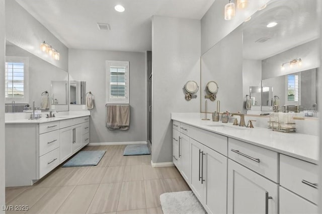 7456 Tinley Creek Ave, Las Vegas, NV 89113 - full bathroom featuring healthy amount of natural light, two vanities, and tile patterned floors
