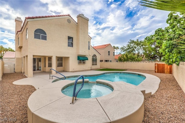 2107 Fountain Springs Dr, Henderson, NV 89074 - view of swimming pool featuring a patio, a fenced backyard, and a pool with connected hot tub