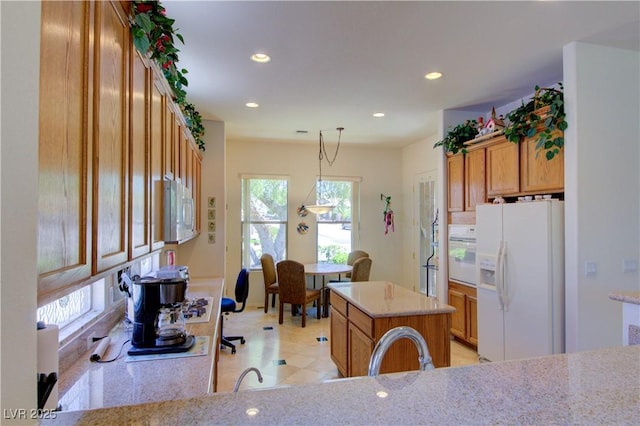 2026 Poppywood Ave, Henderson, NV 89012 - kitchen with white appliances, recessed lighting, decorative light fixtures, brown cabinets, and a kitchen island