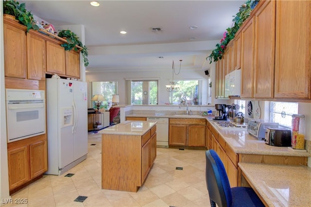 2026 Poppywood Ave, Henderson, NV 89012 - kitchen featuring white appliances, a peninsula, a center island, recessed lighting, and light stone counters