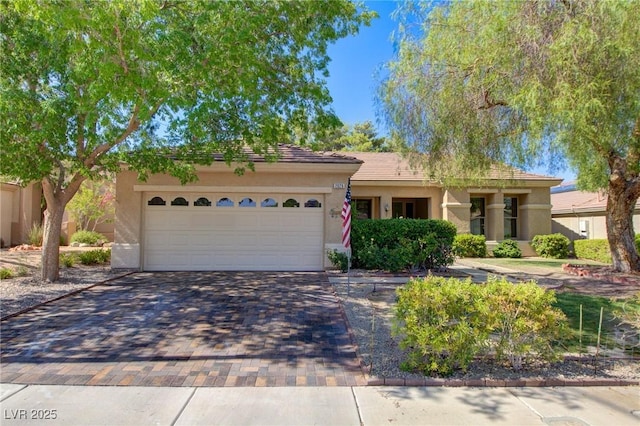 2026 Poppywood Ave, Henderson, NV 89012 - ranch-style home with stucco siding, a garage, and decorative driveway