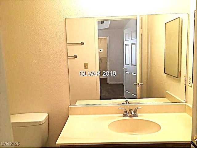 8417 Running Deer Ave Unit 101, Las Vegas, NV 89145 - half bathroom with a textured wall and vanity