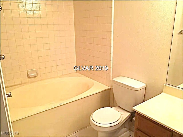 8417 Running Deer Ave Unit 101, Las Vegas, NV 89145 - full bathroom featuring vanity,  shower combination, tile patterned floors, and a textured wall