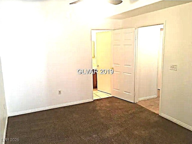 8417 Running Deer Ave Unit 101, Las Vegas, NV 89145 - unfurnished bedroom featuring baseboards and carpet flooring