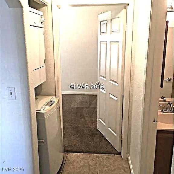 8417 Running Deer Ave Unit 101, Las Vegas, NV 89145 - laundry room with washer / dryer and tile patterned floors