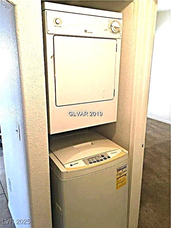 8417 Running Deer Ave Unit 101, Las Vegas, NV 89145 - laundry room featuring stacked washer / dryer