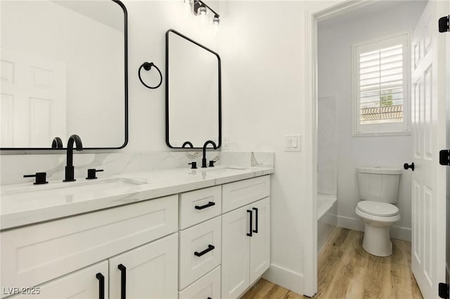10302 Artful Stone Ave, Las Vegas, NV 89149 - bathroom featuring double vanity, wood finished floors, and tub / shower combination