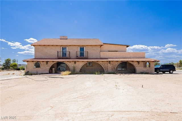 8335 Rancho Destino Rd, Las Vegas, NV 89123 - view of front of home with a balcony and a chimney