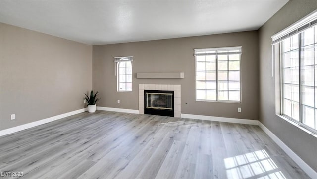 507 Satin Saddle Pl, Henderson, NV 89052 - unfurnished living room featuring wood finished floors and a tile fireplace